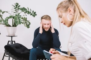 Psychologist writing notes about a patient during a mental health evaluation
